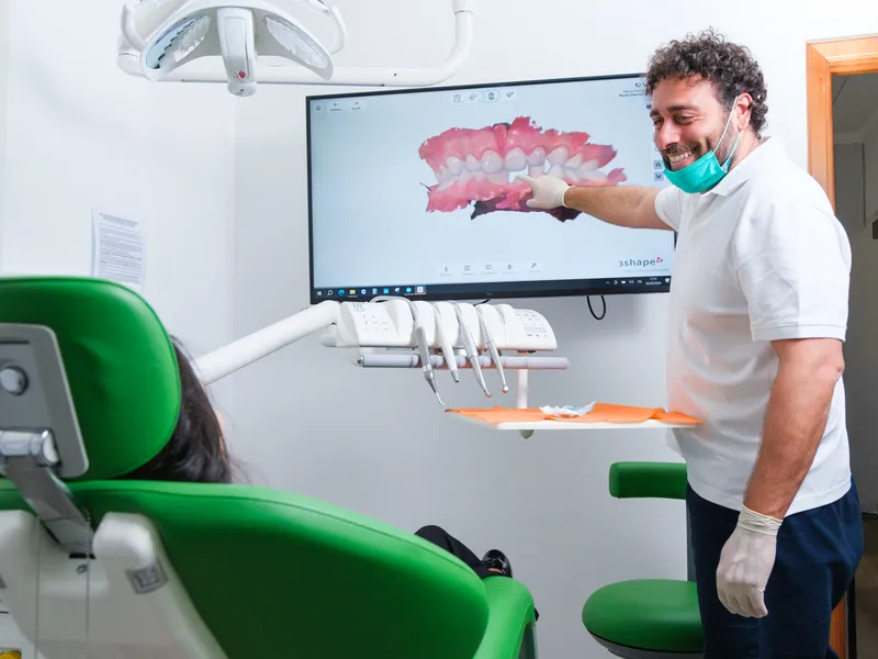 Dottore indica sullo schermo la scansione di una arcata dentale